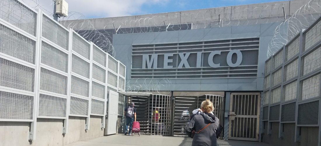 A woman crosses the border from San Diego to Tijuana.